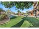 Lush backyard with mature trees, a sparkling pool, and a relaxing hot tub, offering a serene retreat at 26475 N Wrangler Rd, Scottsdale, AZ 85255