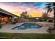 Beautiful backyard with a shimmering pool, lush greenery, and a seamless blend of nature and luxury at 26475 N Wrangler Rd, Scottsdale, AZ 85255