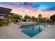 Resort-style backyard with a sparkling pool, lush landscaping, and a covered patio, perfect for outdoor entertaining at 26475 N Wrangler Rd, Scottsdale, AZ 85255