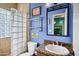 Stylish bathroom featuring glass block shower, floating shelves, and granite countertop at 26475 N Wrangler Rd, Scottsdale, AZ 85255