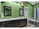 Bathroom with a soaking tub, double sinks, black cabinets, and modern finishes at 26475 N Wrangler Rd, Scottsdale, AZ 85255