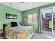 Bright and airy bedroom with sliding glass door and view to backyard at 26475 N Wrangler Rd, Scottsdale, AZ 85255