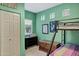 Bedroom featuring bunk beds, closet, dresser, and square windows with a view at 26475 N Wrangler Rd, Scottsdale, AZ 85255