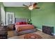 Bright bedroom with wood-look tile flooring, a ceiling fan, and views to a window at 26475 N Wrangler Rd, Scottsdale, AZ 85255