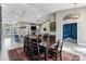 Elegant dining room with dark wood table, seating for six, and kitchen view at 26475 N Wrangler Rd, Scottsdale, AZ 85255