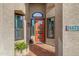 Close-up shot of the front entrance with a bright orange door and tile porch at 26475 N Wrangler Rd, Scottsdale, AZ 85255