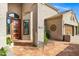 Close up of front entrance with orange front door and terra cotta tiled porch at 26475 N Wrangler Rd, Scottsdale, AZ 85255