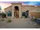 Charming single-story home featuring a desert-landscaped yard and a cozy front porch, perfect for enjoying quiet evenings at 26475 N Wrangler Rd, Scottsdale, AZ 85255