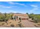Charming home with a well-maintained front yard, desert landscaping, and a three-car garage at 26475 N Wrangler Rd, Scottsdale, AZ 85255