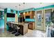 Stylish kitchen with a granite countertop, stainless steel appliances, bar seating, and a unique blue wall color at 26475 N Wrangler Rd, Scottsdale, AZ 85255