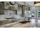 Gorgeous kitchen features a marble countertop, stone backsplash and stainless appliances at 26475 N Wrangler Rd, Scottsdale, AZ 85255