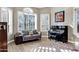 Cozy living area showcasing a loveseat, piano, and plantation shutters at 26475 N Wrangler Rd, Scottsdale, AZ 85255