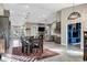 Open concept kitchen and dining area flowing into a cozy living space with fireplace at 26475 N Wrangler Rd, Scottsdale, AZ 85255