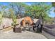 Cozy outdoor fireplace with comfortable seating area at 26475 N Wrangler Rd, Scottsdale, AZ 85255