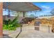 Outdoor kitchen area featuring BBQ and water feature at 26475 N Wrangler Rd, Scottsdale, AZ 85255