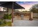 Well-equipped outdoor kitchen with a built-in grill, stone countertops, and ample prep space for culinary adventures at 26475 N Wrangler Rd, Scottsdale, AZ 85255