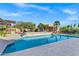 Sparkling pool with a waterfall feature and a view of the casita, surrounded by desert landscaping at 26475 N Wrangler Rd, Scottsdale, AZ 85255