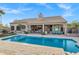 A beautiful backyard featuring a pool, covered patio, and well-manicured landscaping for outdoor living at 26475 N Wrangler Rd, Scottsdale, AZ 85255