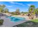 Beautiful pool with a waterfall feature and a pergola, surrounded by desert landscaping and perfect for summer fun at 26475 N Wrangler Rd, Scottsdale, AZ 85255