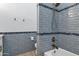 Detailed view of the shower featuring blue tiling, shower head and bronze shower fixture at 26475 N Wrangler Rd, Scottsdale, AZ 85255