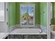 Bathroom featuring a tub with hexagon tile surround and shuttered window at 26475 N Wrangler Rd, Scottsdale, AZ 85255