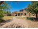 Expansive backyard with a stone pathway and lush trees providing shade at 278 S San Luis Rey Trl, Casa Grande, AZ 85194