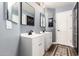 Updated bathroom features double sinks, white cabinets, wood-look flooring, and modern fixtures at 278 S San Luis Rey Trl, Casa Grande, AZ 85194