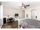 Bedroom with wood-style flooring, ceiling fan, and desk area, offering comfort and functionality at 278 S San Luis Rey Trl, Casa Grande, AZ 85194