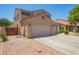 Two-story home featuring a three-car garage, well-manicured landscaping, and neutral color scheme at 278 S San Luis Rey Trl, Casa Grande, AZ 85194