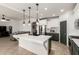 Open-concept kitchen featuring a large island, stainless steel appliances, and modern lighting at 278 S San Luis Rey Trl, Casa Grande, AZ 85194