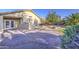 Backyard includes patio, mature tree and rock landscaping at 29384 N Rosewood Dr, San Tan Valley, AZ 85143