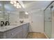 Bathroom with double sinks, granite countertops and a glass shower at 29384 N Rosewood Dr, San Tan Valley, AZ 85143