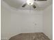 Neutral carpet in a bedroom featuring a ceiling fan and white door at 29384 N Rosewood Dr, San Tan Valley, AZ 85143