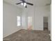 Bedroom with plush carpet, bright natural light and ceiling fan at 29384 N Rosewood Dr, San Tan Valley, AZ 85143