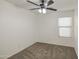 Cozy bedroom with neutral carpet, ceiling fan and a window at 29384 N Rosewood Dr, San Tan Valley, AZ 85143