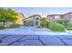 Single-story home with two car garage, desert landscaping, and wide driveway at 29384 N Rosewood Dr, San Tan Valley, AZ 85143