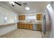 Well-lit kitchen with stainless steel appliances, oak cabinets, and tile floors at 29384 N Rosewood Dr, San Tan Valley, AZ 85143