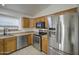 Bright kitchen featuring oak cabinets, stainless steel appliances, and tile flooring at 29384 N Rosewood Dr, San Tan Valley, AZ 85143