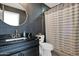 Full bathroom featuring black vanity, gold fixtures, textured wallpaper, and shower with shower curtain at 2946 N 14Th St # 37, Phoenix, AZ 85014