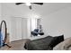 Bedroom with closet, ceiling fan, and a desk with laptop by the window at 2946 N 14Th St # 37, Phoenix, AZ 85014