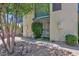 Two-story townhome exterior with mature trees and partial sidewalk view at 2946 N 14Th St # 37, Phoenix, AZ 85014