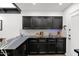 Modern kitchen with black cabinetry, white subway tile backsplash, and black countertops with white veining at 2946 N 14Th St # 37, Phoenix, AZ 85014