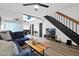Modern living room featuring hardwood floors, comfortable seating, and a staircase to the upper level at 2946 N 14Th St # 37, Phoenix, AZ 85014