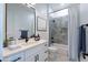This bathroom boasts a modern vanity, hexagon-tiled shower, and a clean, stylish design at 29587 N 156Th St, Scottsdale, AZ 85262