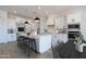 Modern kitchen with stainless steel appliances, quartz countertops, and a large island with seating at 29587 N 156Th St, Scottsdale, AZ 85262