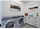 Functional laundry room featuring modern washer and dryer and ample storage space at 29587 N 156Th St, Scottsdale, AZ 85262