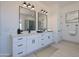 Bright bathroom featuring dual vanities, sleek fixtures, and a stylish tile shower at 29587 N 156Th St, Scottsdale, AZ 85262