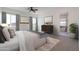 Relaxing bedroom featuring soft carpet, a large bed, and a bright ensuite bathroom at 29587 N 156Th St, Scottsdale, AZ 85262