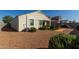 Lush backyard with gravel, artificial turf, patio furniture, and inviting landscaping features at 3026 N 305Th Dr, Buckeye, AZ 85396