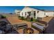 Expansive backyard with gravel landscaping, patio seating, and an inviting fire pit area at 3026 N 305Th Dr, Buckeye, AZ 85396